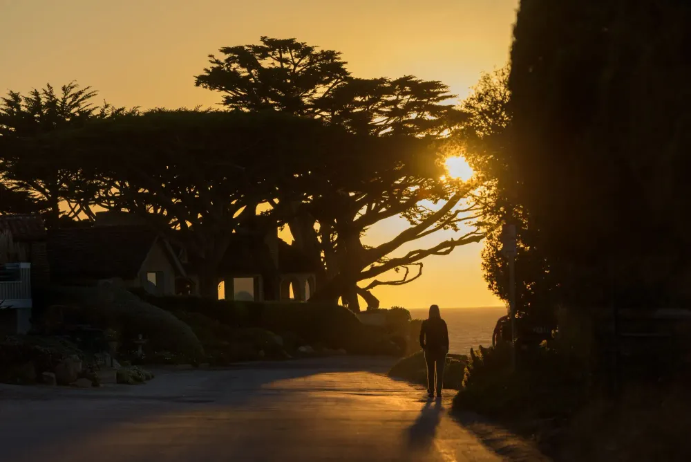 Woman walking at sunset in Carmel-by-the-Sea